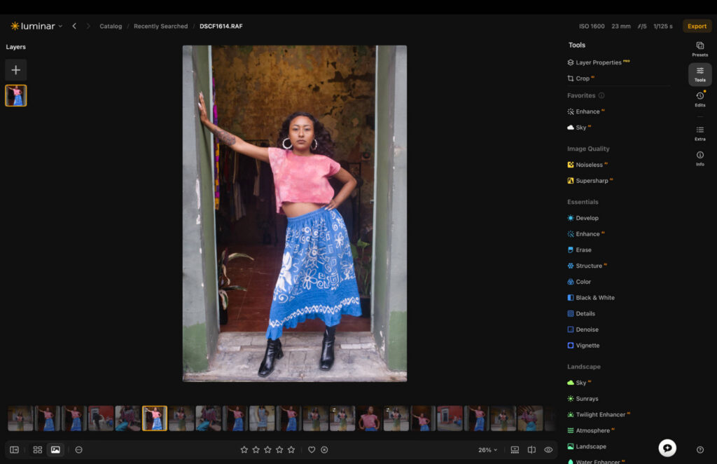 Luminar Neo's full user interface showing a portrait photo of a woman in a doorway, with the compact left-hand tools menu and dark themed design