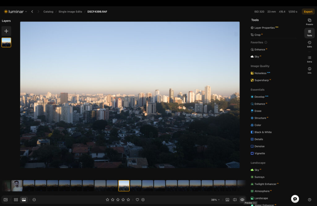 Luminar Neo editing interface showing the Sky tools panel with an original cityscape RAW photo and hazy sky before replacement