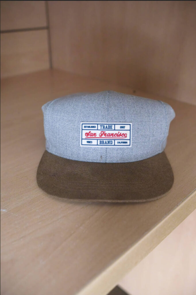 Close-up crop of the baseball cap's fabric texture on a wooden shelf after ON1 Photo RAW's NoNoise AI has been applied, showing reduced image noise