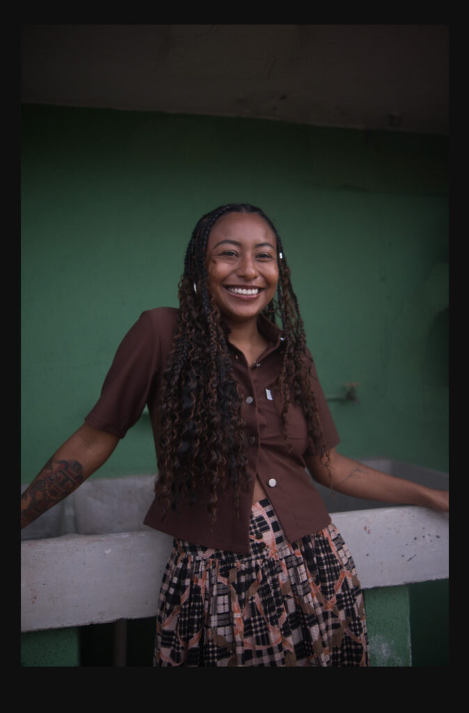 Portrait of the woman against the green wall with the background concrete structure removed using Luminar Neo's generative erase tool